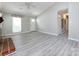Bright living room featuring sleek gray flooring, a fireplace, and a modern ceiling fan at 2502 Breuster Dr, Charlotte, NC 28210