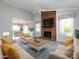 Living room featuring a brick fireplace, large windows, and neutral-toned furniture at 2502 Breuster Dr, Charlotte, NC 28210