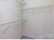 Empty walk-in closet features wire shelving on walls and wood-look flooring at 2502 Breuster Dr, Charlotte, NC 28210