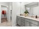 Modern bathroom features double vanity with granite countertops, stylish fixtures, and a walk-in closet at 2585 Blue Sky Meadows Dr, Monroe, NC 28110