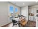 Bright dining area with french doors and a view of the yard and modern table with bench at 2585 Blue Sky Meadows Dr, Monroe, NC 28110