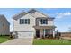 Charming two-story home with attached garage, inviting porch, and beautifully landscaped front yard at 2585 Blue Sky Meadows Dr, Monroe, NC 28110