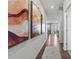 Bright hallway featuring hardwood floors and decorative wall art leading to the dining area at 2585 Blue Sky Meadows Dr, Monroe, NC 28110