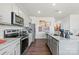 Contemporary kitchen with gray cabinetry, stainless steel appliances, and a granite-topped island at 2585 Blue Sky Meadows Dr, Monroe, NC 28110