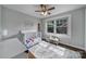 This Bedroom features hardwood floors, a ceiling fan, and large windows for natural light at 2626 Lilly Mill Rd, Charlotte, NC 28210