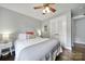 Comfortable bedroom features hardwood floors, a ceiling fan, and a bright window at 2626 Lilly Mill Rd, Charlotte, NC 28210