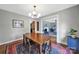 Dining room with wood table and rug, opening to living room at 2626 Lilly Mill Rd, Charlotte, NC 28210