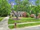 Beautiful home showcasing its spacious front yard, complemented by mature trees and landscaping at 2626 Lilly Mill Rd, Charlotte, NC 28210