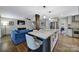 Modern kitchen with a spacious island, seating, stainless steel appliances, and easy access to the living room at 2626 Lilly Mill Rd, Charlotte, NC 28210