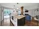 Stylish kitchen featuring a large island with seating, pendant lighting, and an open view to the living area at 2626 Lilly Mill Rd, Charlotte, NC 28210