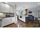Open-concept kitchen with granite island, stainless appliances, and hardwood floors at 2626 Lilly Mill Rd, Charlotte, NC 28210