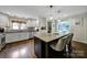 Bright kitchen boasts granite counters, an island with seating, and stainless steel appliances at 2626 Lilly Mill Rd, Charlotte, NC 28210