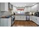 Clean kitchen with stainless steel appliances, white cabinets, and wooden floors at 2626 Lilly Mill Rd, Charlotte, NC 28210