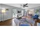 Well-lit living room with hardwood floors, inviting furniture, and an open connection to the dining area at 2626 Lilly Mill Rd, Charlotte, NC 28210