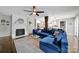 Open-concept living room featuring hardwood floors, a fireplace, and a seamless flow into the kitchen at 2626 Lilly Mill Rd, Charlotte, NC 28210