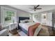 Comfortable main bedroom featuring an ensuite bathroom, ceiling fan, and windows for natural light at 2626 Lilly Mill Rd, Charlotte, NC 28210
