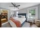 Cozy main bedroom includes a walk-in closet, bedside tables, and windows for light at 2626 Lilly Mill Rd, Charlotte, NC 28210