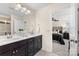 Stylish bathroom with double sink vanity, tile flooring, and a view of the bedroom at 2638 Double Oaks Rd, Charlotte, NC 28206