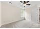 Bright bedroom featuring neutral carpet, ceiling fan, and ample natural light from the window at 2638 Double Oaks Rd, Charlotte, NC 28206