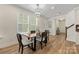 Dining area with modern chandelier, lots of natural light, and stairs to second floor at 2638 Double Oaks Rd, Charlotte, NC 28206