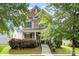 Inviting two-story home featuring a mix of brick and siding, a welcoming porch, and neat landscaping at 2638 Double Oaks Rd, Charlotte, NC 28206