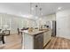 Open-concept kitchen island featuring stainless steel appliances and bright lighting at 2638 Double Oaks Rd, Charlotte, NC 28206