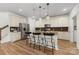 Open kitchen with stainless steel appliances, eat-in island, and modern finishes at 2638 Double Oaks Rd, Charlotte, NC 28206