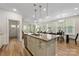 Kitchen with stainless steel appliances, eat-in island, and views to the dining and living spaces at 2638 Double Oaks Rd, Charlotte, NC 28206
