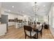 Open-concept kitchen and dining area with stainless appliances and eat-in island at 2638 Double Oaks Rd, Charlotte, NC 28206