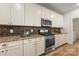 Bright kitchen with stainless steel appliances, granite countertops, and tile backsplash at 2638 Double Oaks Rd, Charlotte, NC 28206