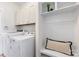 Well-organized laundry room with modern appliances, overhead cabinets, and a convenient folding area at 2638 Double Oaks Rd, Charlotte, NC 28206