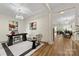 Stylish office with a modern chandelier, tray ceiling, a patterned rug, and a view of an open concept floorplan at 2638 Double Oaks Rd, Charlotte, NC 28206