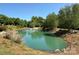 Scenic pond with a fountain and lush landscaping, creating a peaceful and serene environment at 2638 Double Oaks Rd, Charlotte, NC 28206