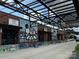 A row of vibrant retail shops with unique art under a sleek, modern awning structure at 2638 Double Oaks Rd, Charlotte, NC 28206