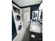 Bathroom with granite counter tops, modern fixtures, and a stacked washer and dryer at 300 S Cedar St # 2, Charlotte, NC 28202