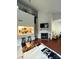 Bright living area with fireplace, dark hardwood floors, and an open kitchen design at 300 S Cedar St # 2, Charlotte, NC 28202
