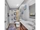 Neutral bathroom with gray walls and floral shower curtain, single vanity, and tile floors at 3578 Saddlebrook Dr, Midland, NC 28107