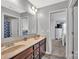 Elegant bathroom with double sinks, wood cabinets and views of Primary bedroom at 3578 Saddlebrook Dr, Midland, NC 28107