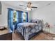 Cozy bedroom with ceiling fan, bedside table, brown carpet and blue accents and bedding set at 3578 Saddlebrook Dr, Midland, NC 28107