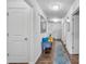 Inviting hallway with hardwood floors, decorative mirror, bench, and a view of the staircase at 3578 Saddlebrook Dr # 182, Midland, NC 28107