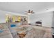 Open-concept living room with plush carpeting, large sofa, and seamless flow into the kitchen and dining areas at 3578 Saddlebrook Dr, Midland, NC 28107