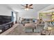 Cozy living room features a large sectional sofa, ceiling fan, and plenty of natural light at 3578 Saddlebrook Dr, Midland, NC 28107