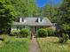 Charming home featuring dormer windows, a walkway, and lush landscaping offering a quaint and inviting curb appeal at 3712 Avalon Ave, Charlotte, NC 28208