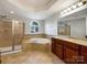 Bathroom featuring a soaking tub, separate shower, and granite countertops at 3904 Hounslow Ln, Harrisburg, NC 28075