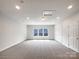 Spacious bedroom with neutral carpet, recessed lights, and a window with a view at 3904 Hounslow Ln, Harrisburg, NC 28075