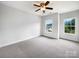 Bedroom featuring carpet, two windows, and great natural light at 3904 Hounslow Ln, Harrisburg, NC 28075