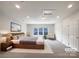 This virtually staged bedroom features carpet, a large bed, a ceiling fan and a window at 3904 Hounslow Ln, Harrisburg, NC 28075