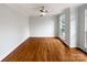 Bright bedroom featuring hardwood floors, a ceiling fan, and a window with natural light at 3904 Hounslow Ln, Harrisburg, NC 28075