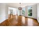 Elegant dining room featuring hardwood floors, large windows, and stylish lighting fixture at 3904 Hounslow Ln, Harrisburg, NC 28075