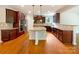 Gourmet kitchen featuring granite countertops, stainless steel appliances, a central island, and hardwood floors at 3904 Hounslow Ln, Harrisburg, NC 28075